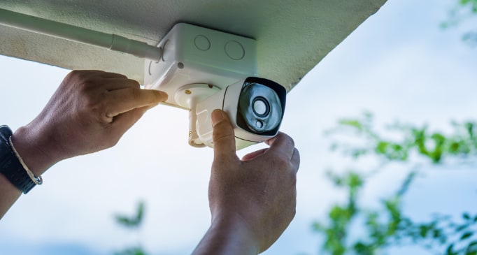 Person adjusting home security camera